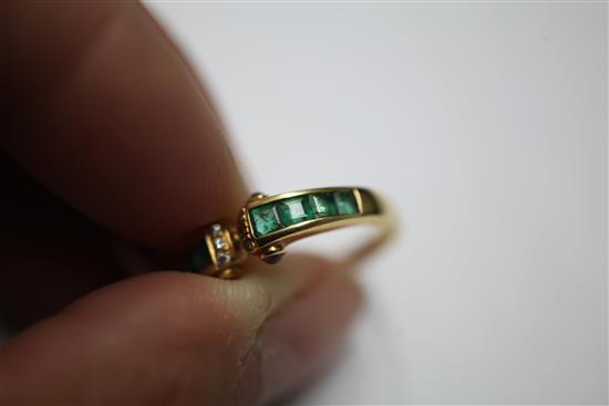 A stylish 18ct gold, emerald and diamond ring, size O.